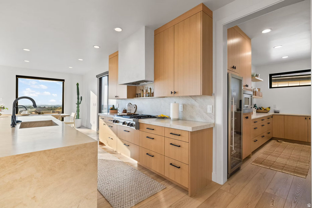 Kitchen featuring light wood finish cabinets, open shelves, modern cabinets, recessed lighting, and light wood-type flooring