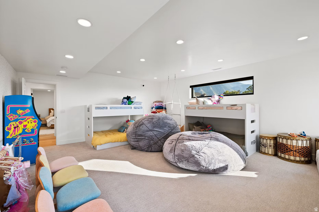 Carpeted bedroom with recessed lighting
