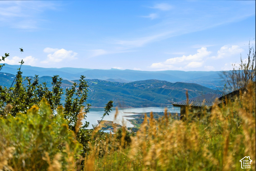 Expansive mountain backdrop with a visible body of water