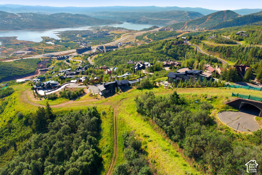 Expansive landscape featuring rolling hills and a distant body of water