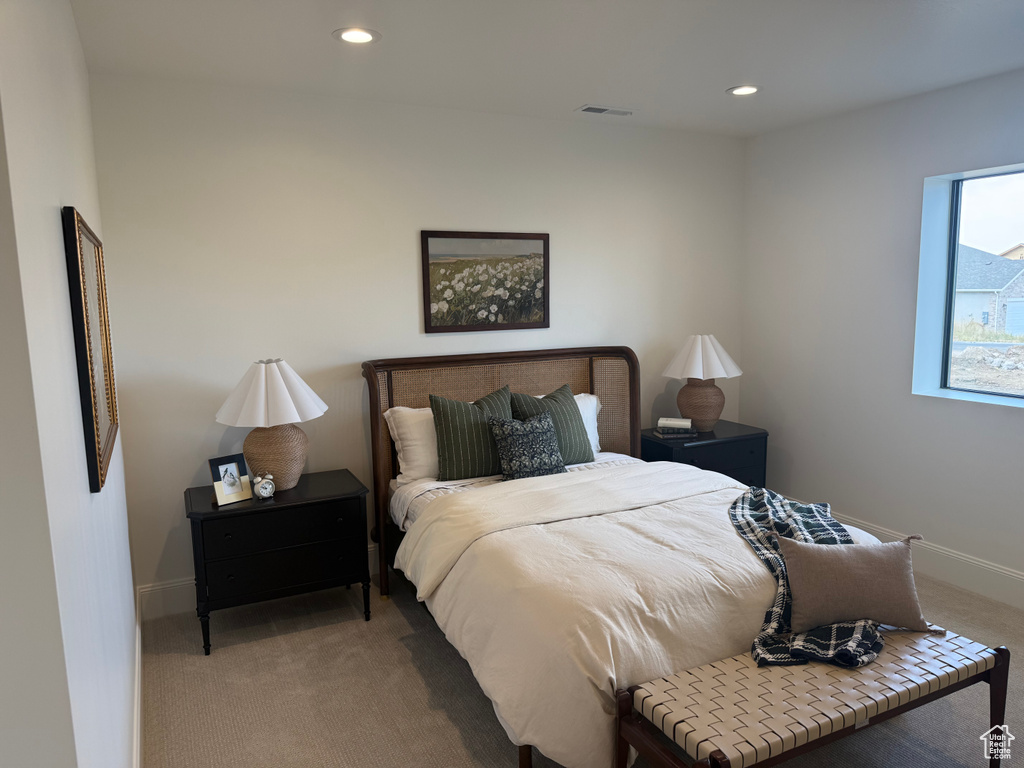 Carpeted bedroom featuring recessed lighting, a window, and light-toned walls