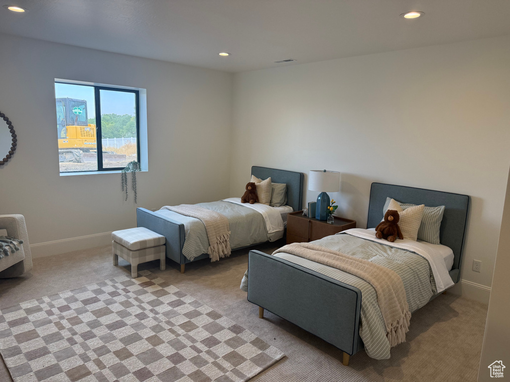 Neutral-toned carpeting and walls complement the recessed lighting