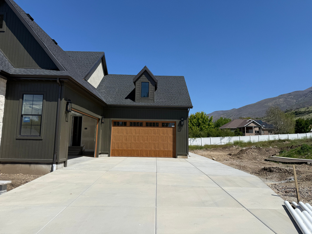 Modern exterior featuring dark vertical siding and a light stone facade