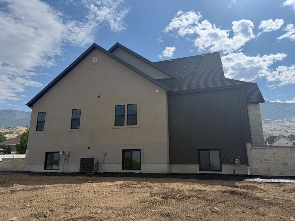 Contemporary exterior featuring stucco, vertical siding, and stone accents