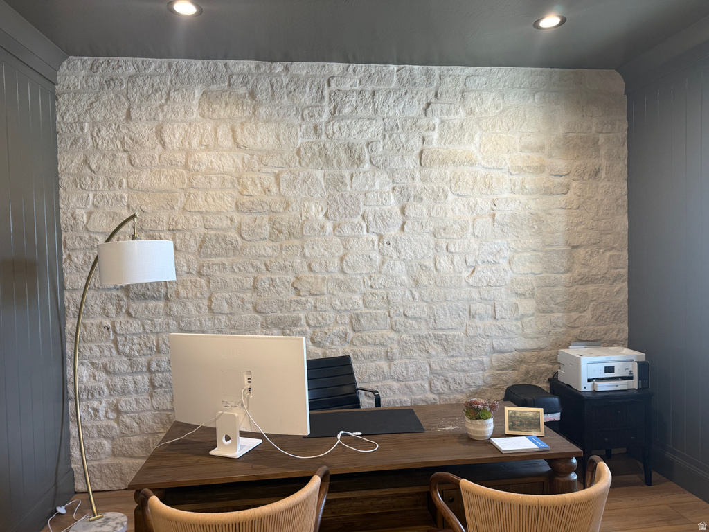 Stone accent wall featuring recessed lighting