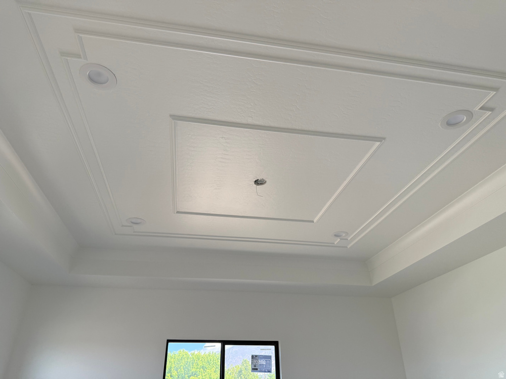 Recessed ceiling with decorative trim, complemented by built-in lighting fixtures
