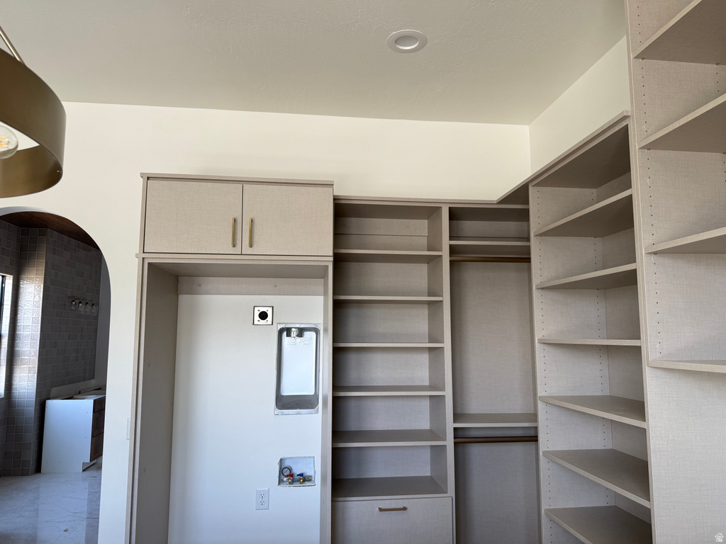 Custom built-in shelving system with integrated laundry appliance space