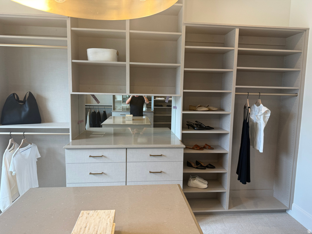 Custom closet system featuring built-in shelving, hanging rods, and integrated drawers