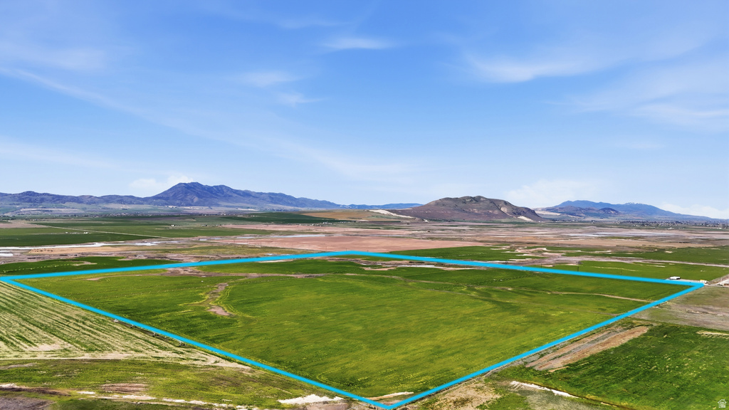 Expansive land parcel featuring open fields and distant mountain scenery