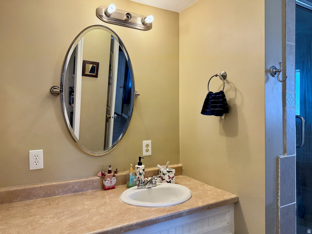 Full bathroom featuring vanity and a stall shower