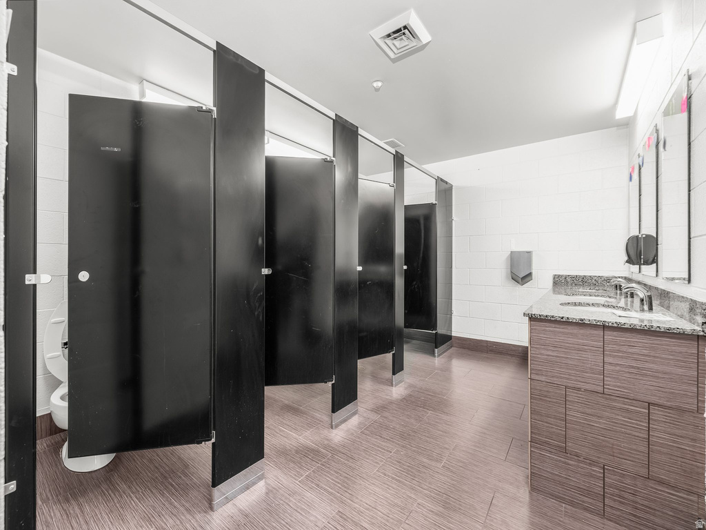 Bathroom featuring vanity and tile walls
