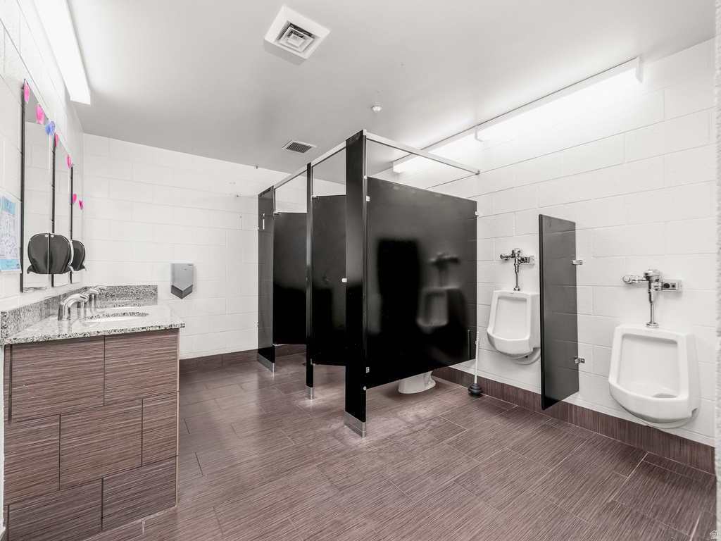 Bathroom with tile walls and concrete block wall
