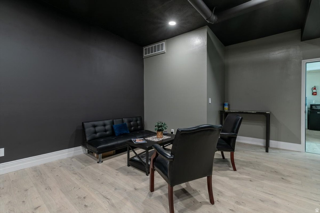 Living area with light wood-style floors and baseboards