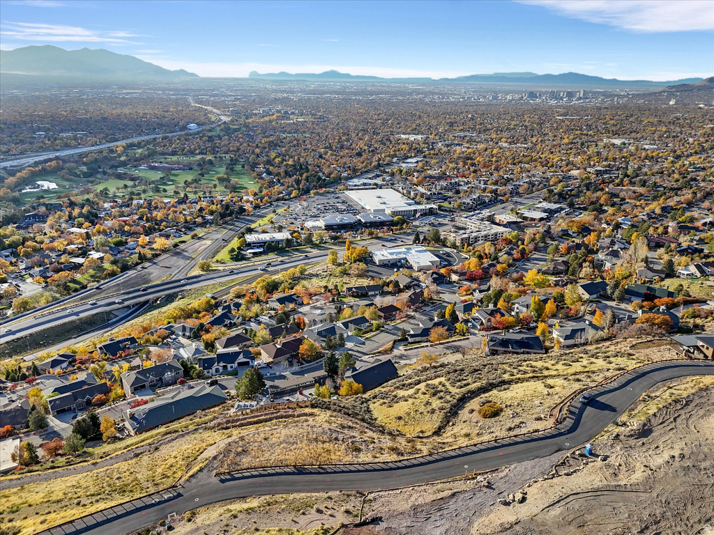 View of property location featuring mountains and nearby suburban area