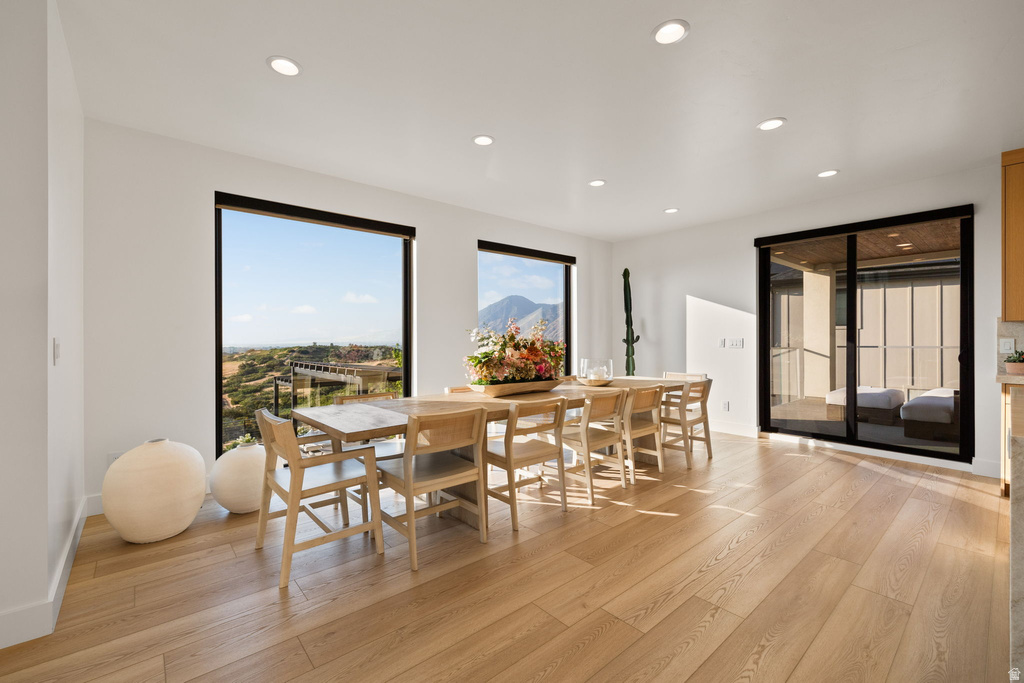 Dining space with light wood finished floors, recessed lighting, and a mountain view