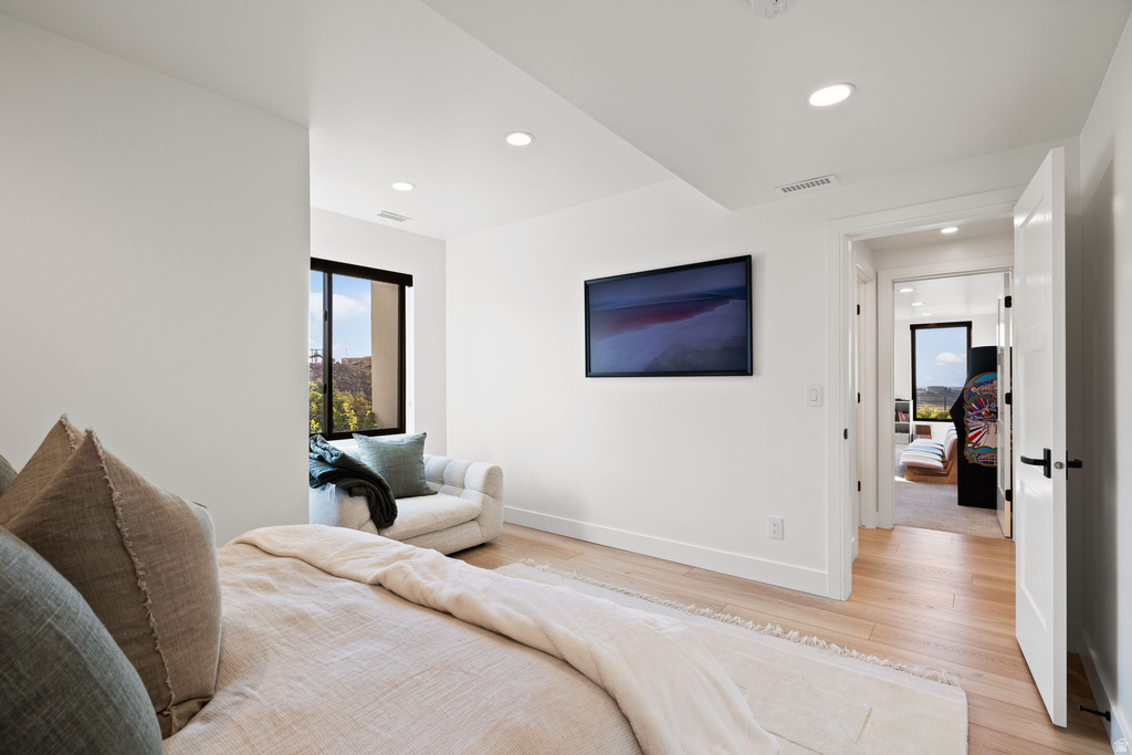 Bedroom with light wood finished floors and recessed lighting