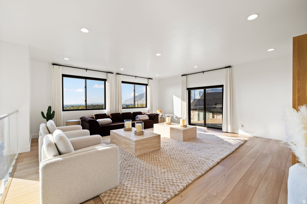 Living area featuring light wood-style flooring and recessed lighting