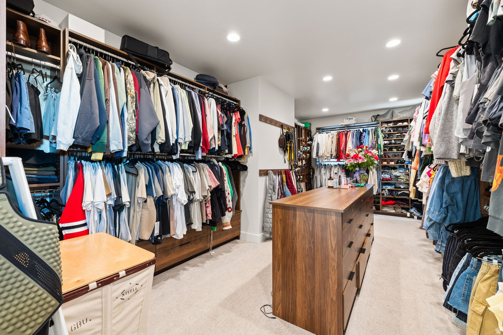 Walk in closet featuring light carpet