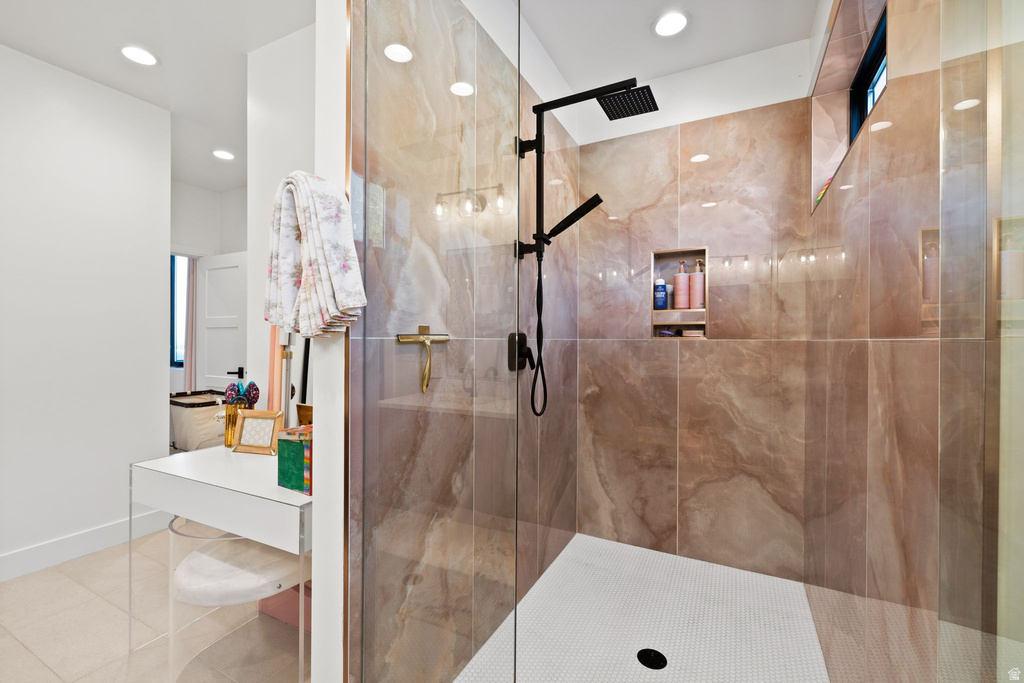 Bathroom with a stall shower, light tile patterned floors, vanity, and recessed lighting