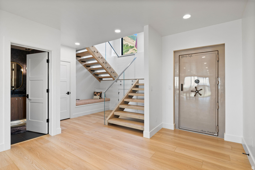 Entrance foyer with light wood-type flooring and recessed lighting