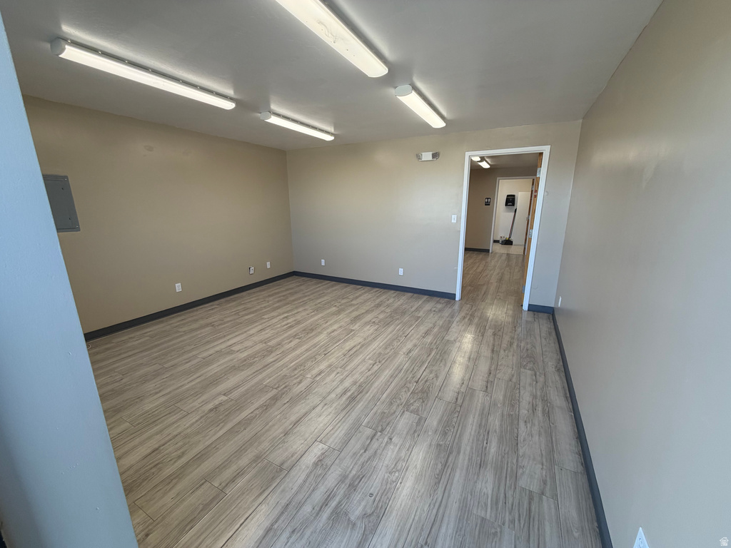 Unfurnished room with wood finished floors and electric panel