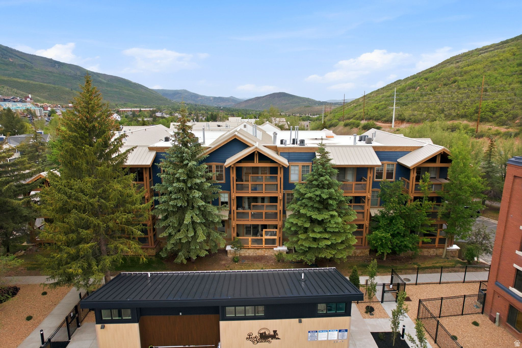 Multi-story residential structure featuring blue siding and natural wood accents