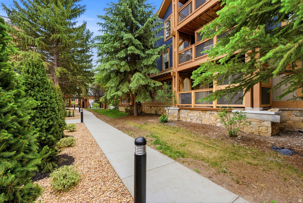 Stone veneer foundation supporting a multi-level structure with screened balconies