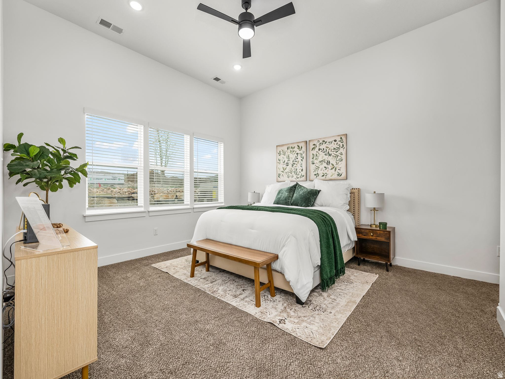Bedroom with dark colored carpet, a ceiling fan, and recessed lighting