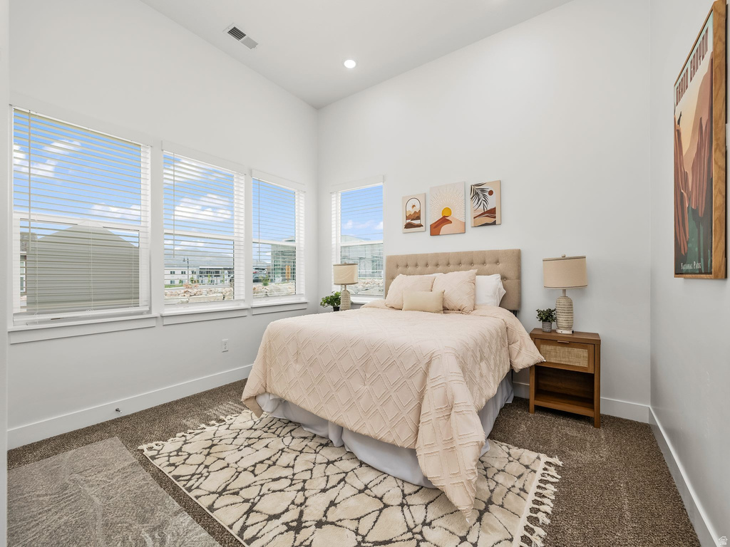 Bedroom featuring dark carpet and recessed lighting