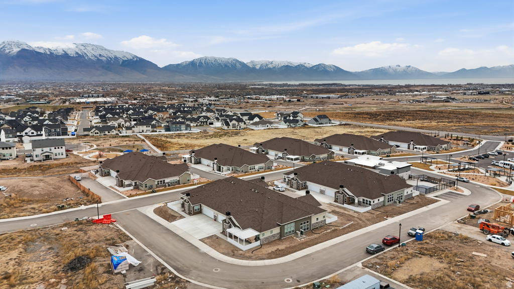 Aerial overview of property\'s location featuring nearby suburban area and a mountainous background