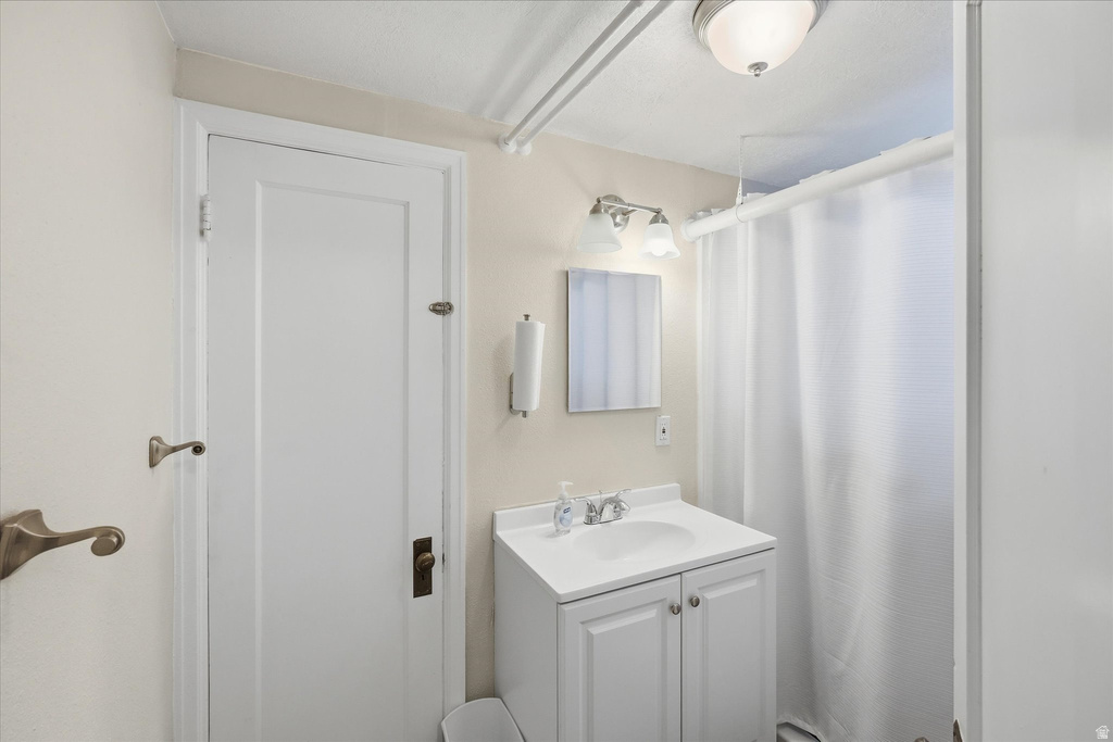 Bathroom featuring vanity and a shower with shower curtain