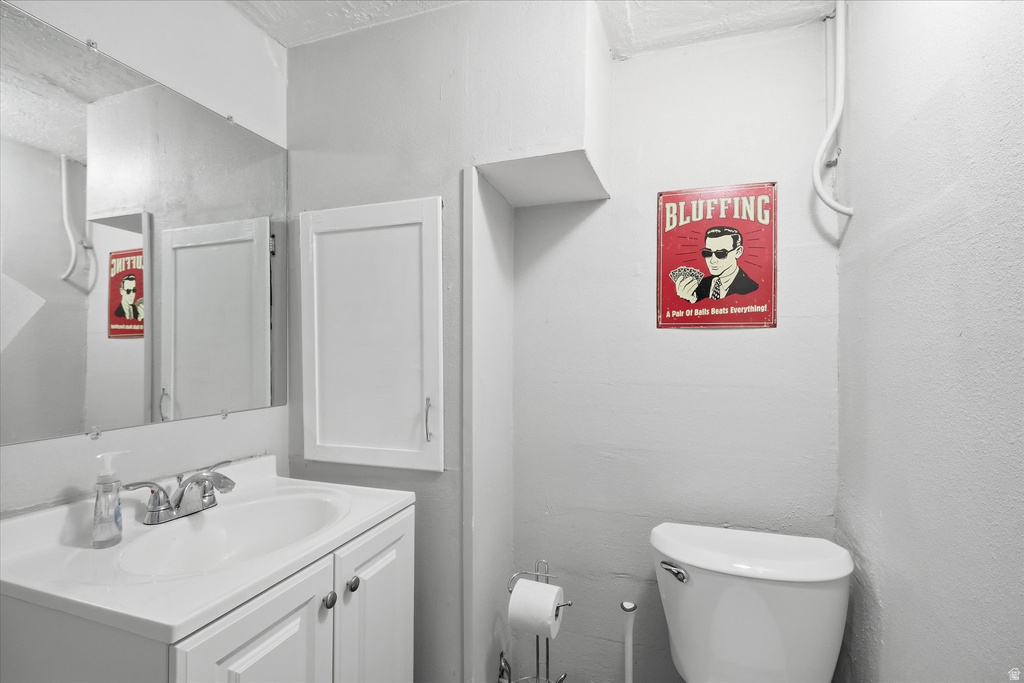 Half bath featuring vanity and toilet