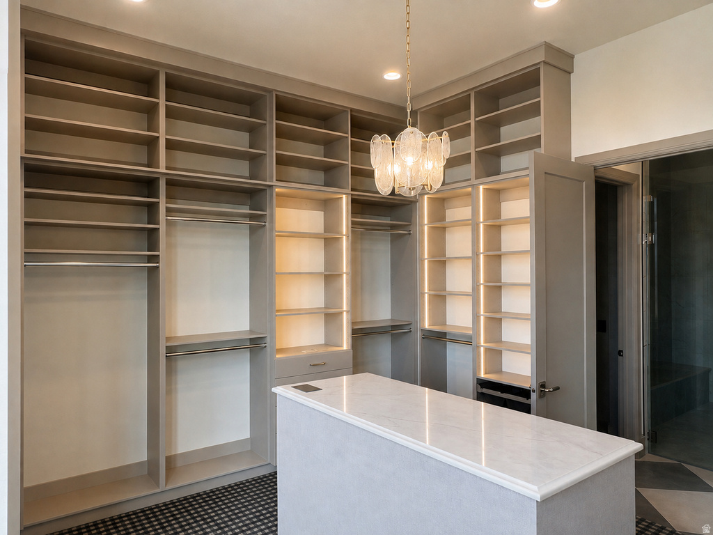 Custom built-in shelving, integrated closet rods, and illuminated display shelves