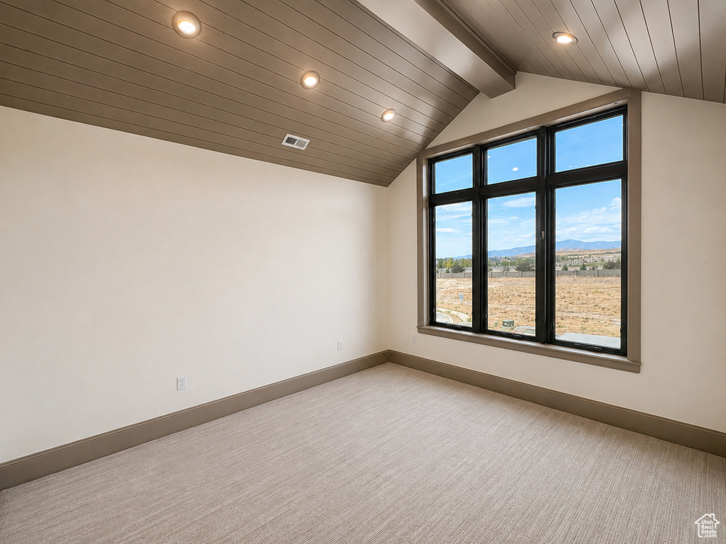 Vaulted ceiling with wood-finish planks, recessed lighting, and a large multi-pane window