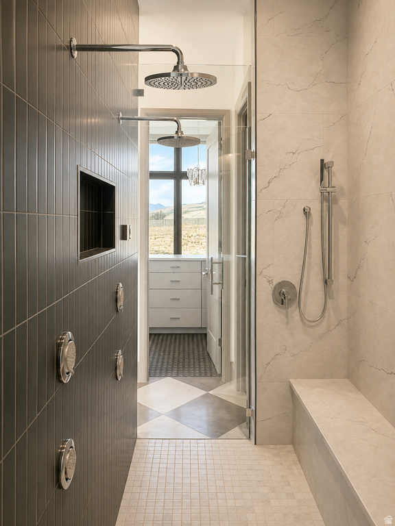 Walk-in shower with dual rain shower heads, a built-in bench, and a hand-held shower fixture