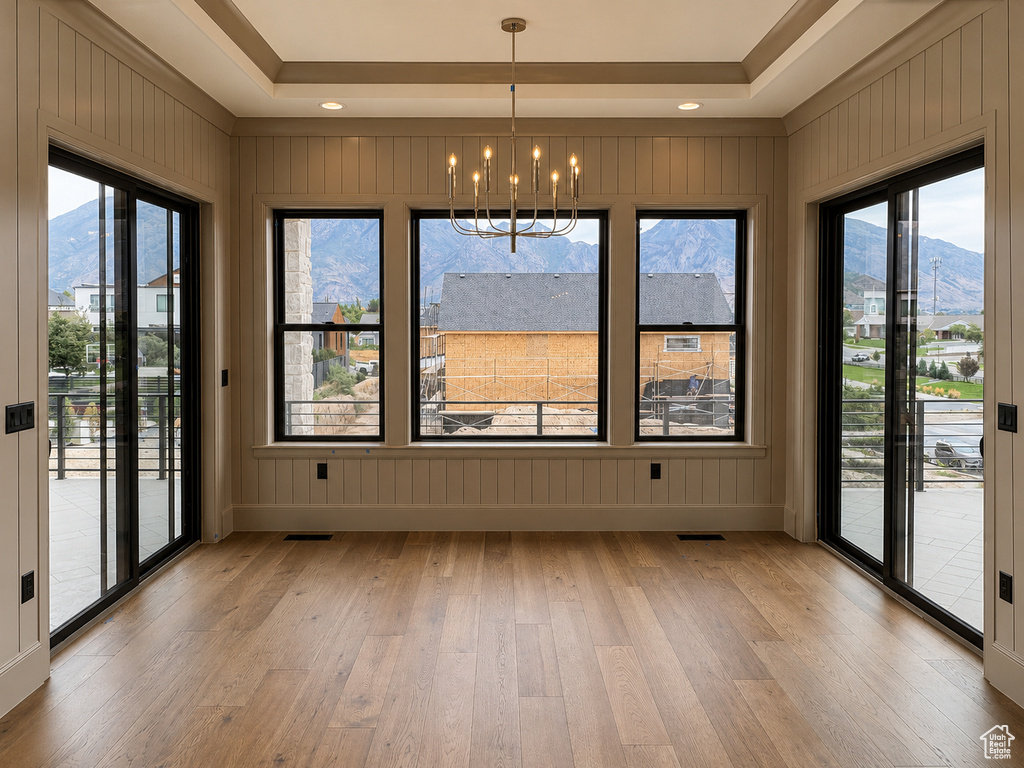 Tray ceiling with recessed lighting and a chandelier
