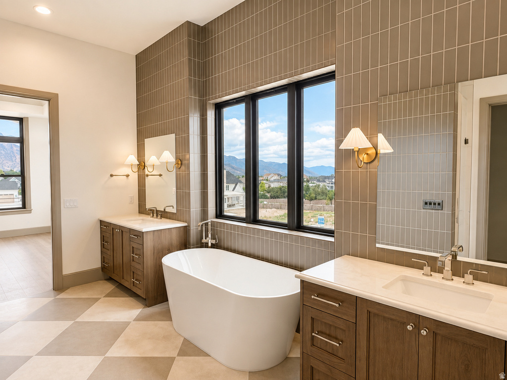 Freestanding soaking tub, dual vanities with light countertops, black-framed windows, vertical tile accent wall, and checkerboard floor tiles