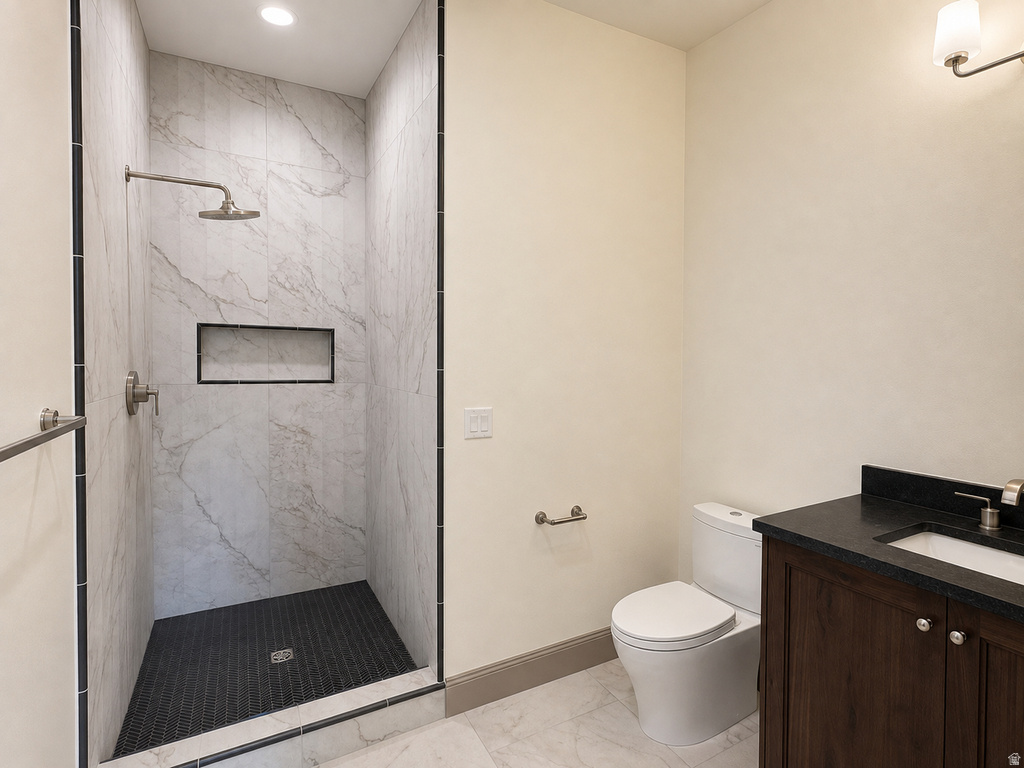 Walk-in shower with large format wall tiles, dark mosaic floor tiles, and a built-in shower niche