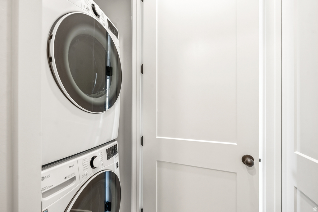 Laundry area featuring stacked washer / drying machine