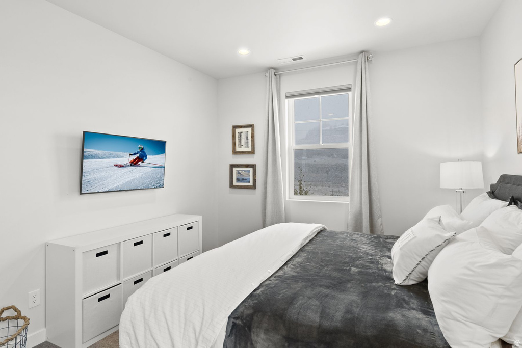 Carpeted bedroom with recessed lighting