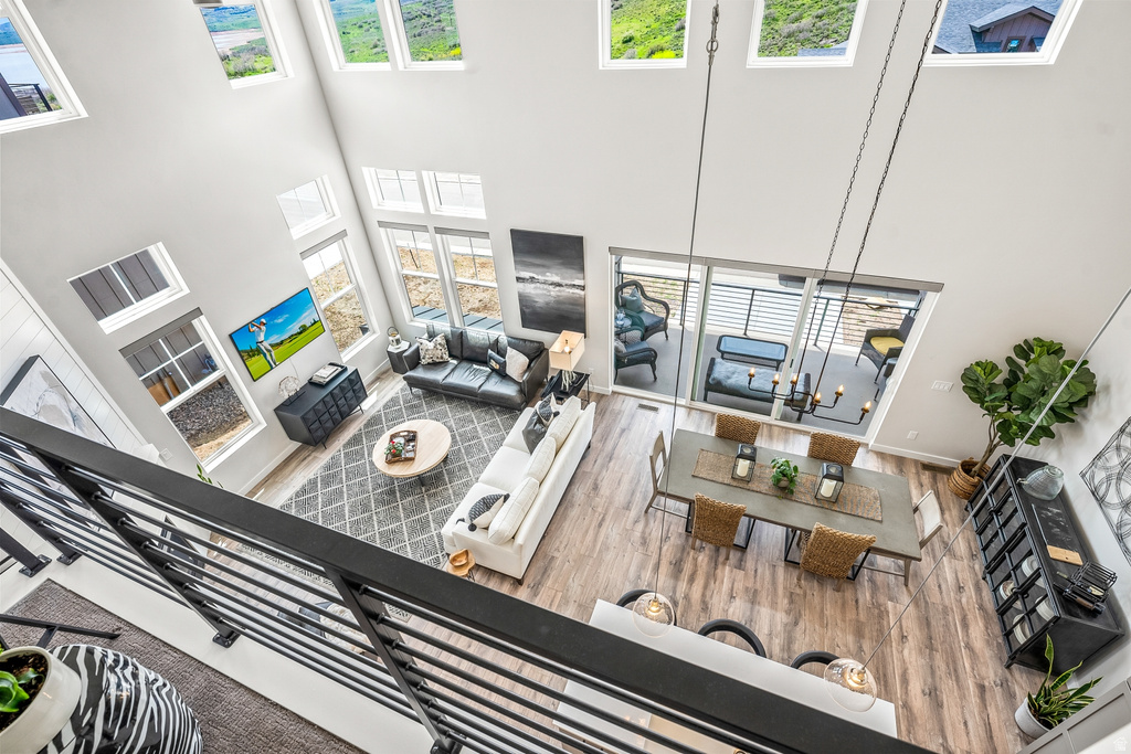 Living room with wood finished floors and a high ceiling
