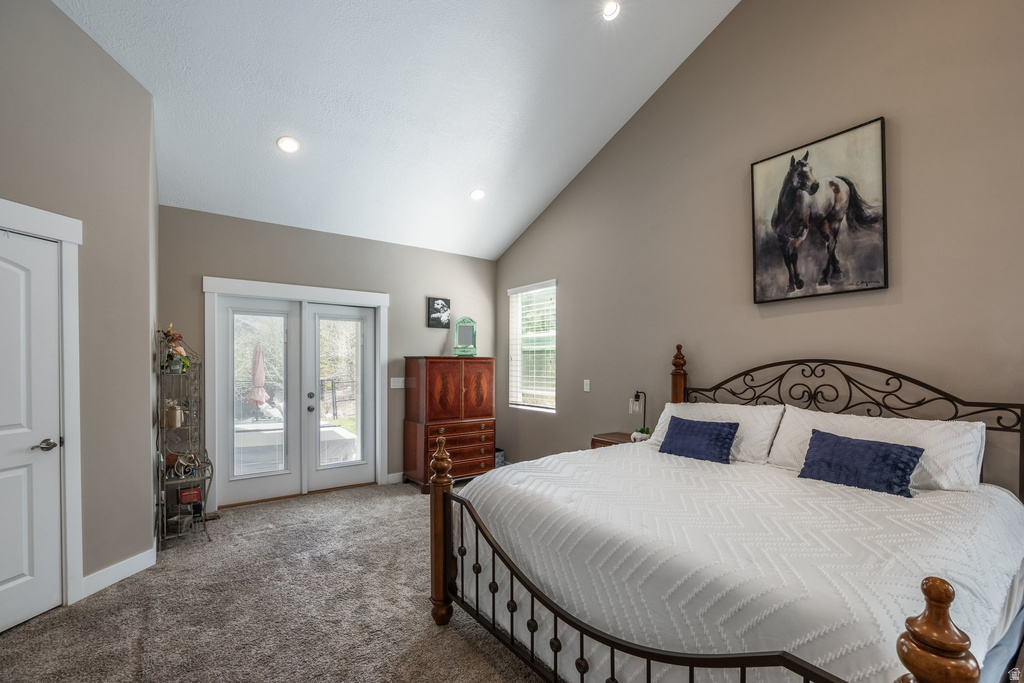 Carpeted bedroom with access to outside, lofted ceiling, french doors, and recessed lighting