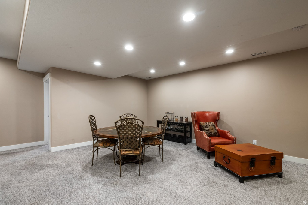 Dining room with light carpet and recessed lighting