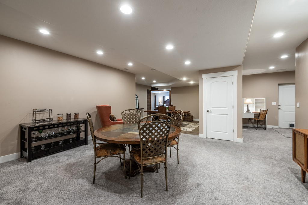 Dining room featuring light carpet and recessed lighting