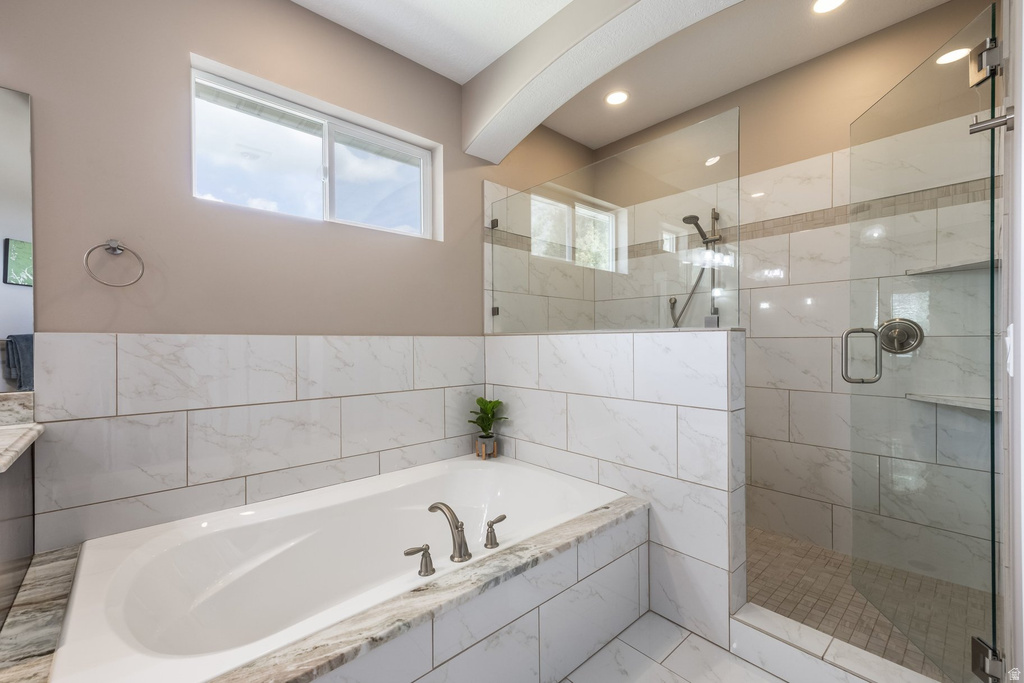 Bathroom with a shower stall, a garden tub, and vanity