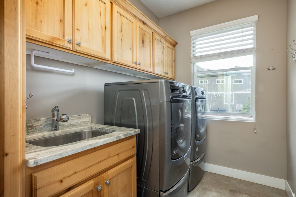 Laundry area with washer and clothes dryer and cabinet space