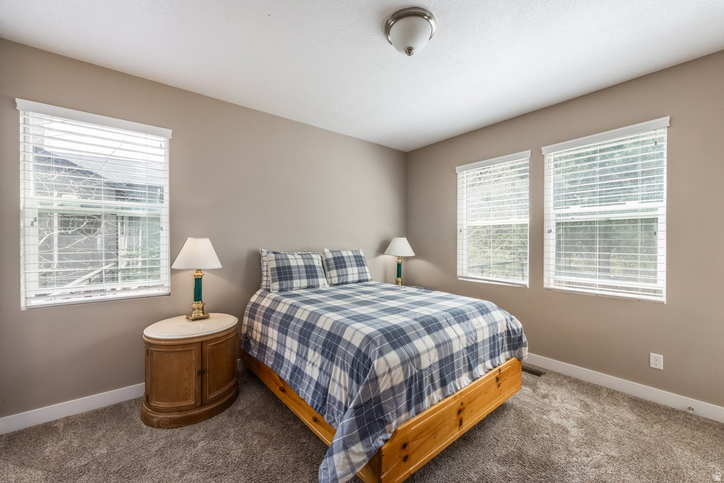 Carpeted bedroom featuring baseboards