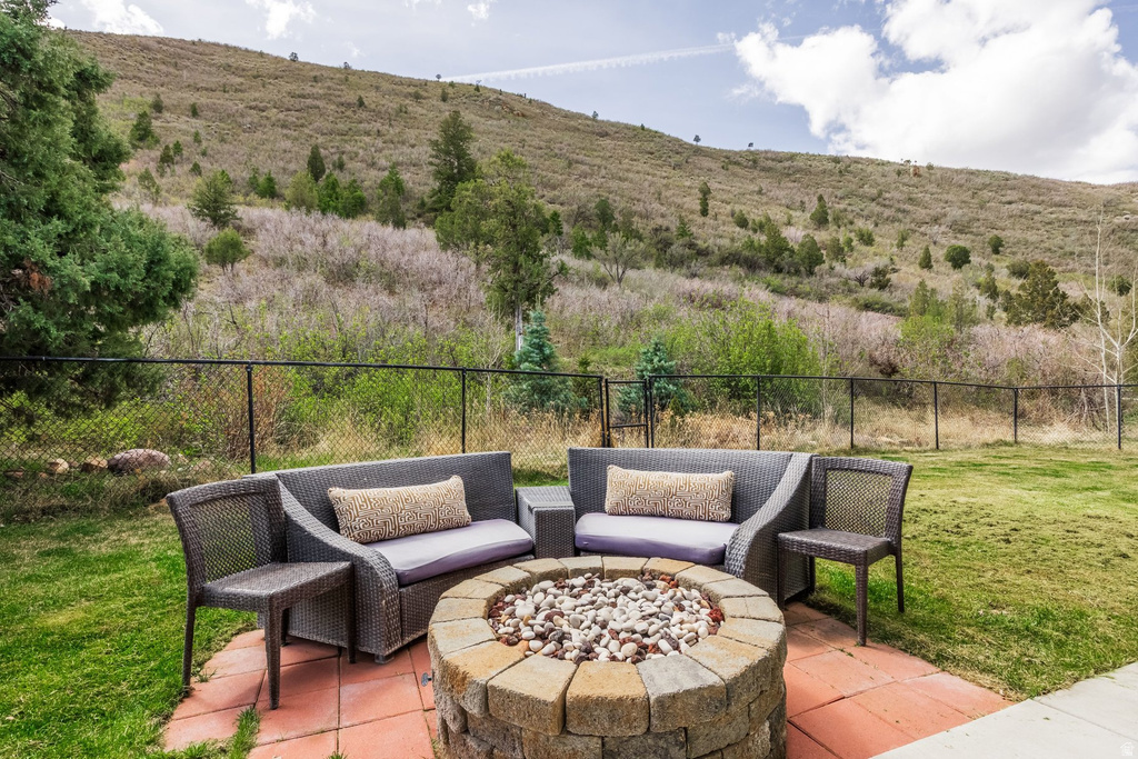 Fenced backyard with a fire pit and a patio area
