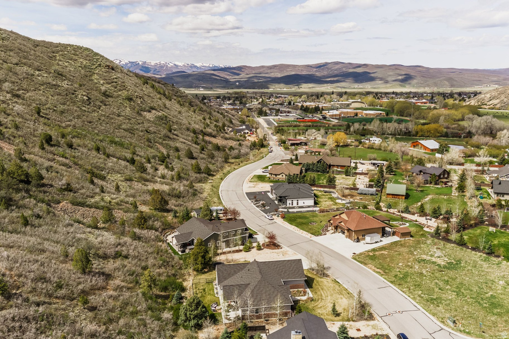 Aerial view of property and surrounding area with a mountainous background