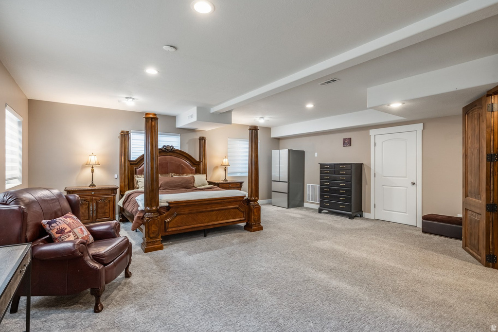Bedroom with light carpet and recessed lighting